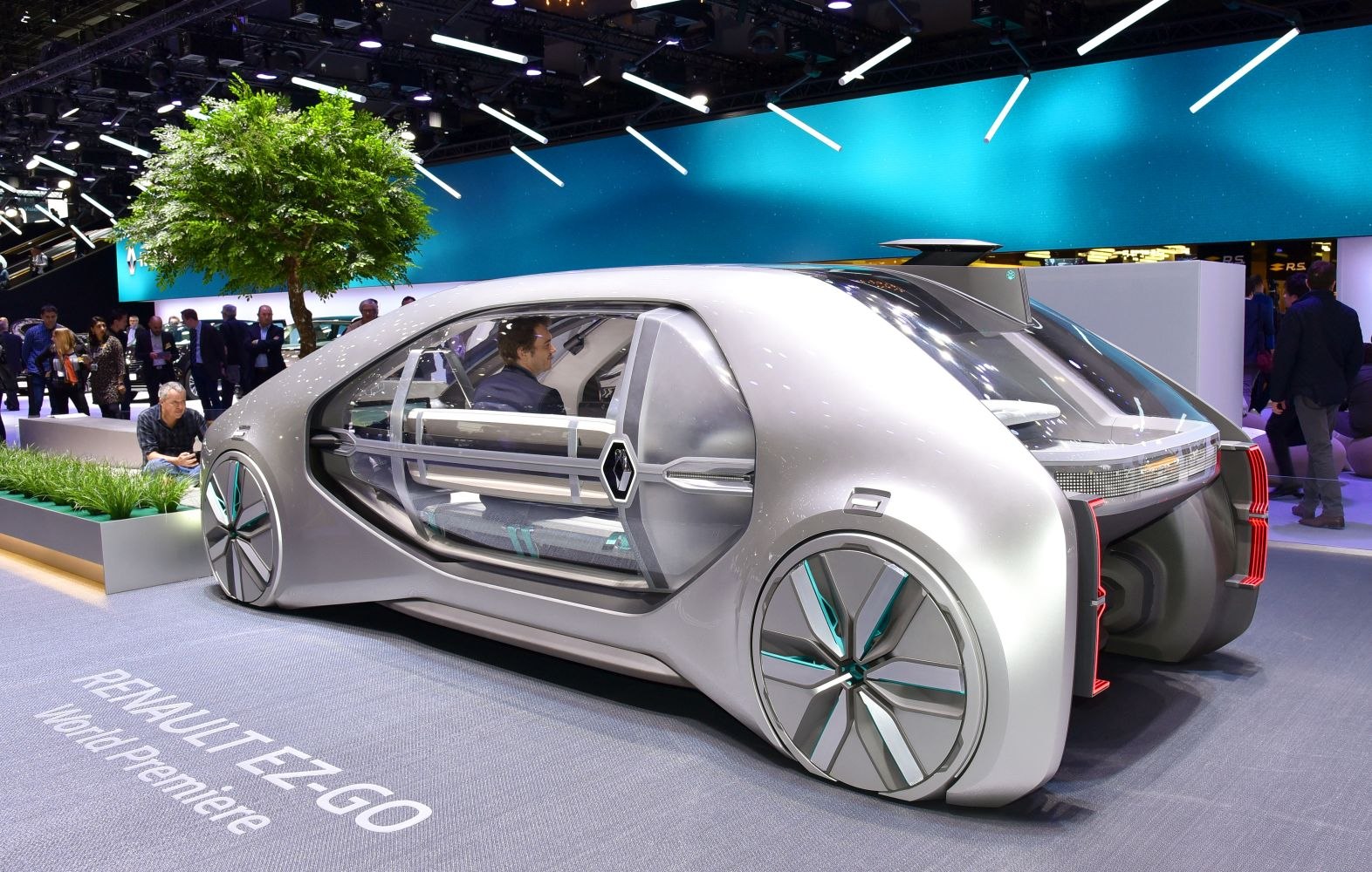 Sleek autonomous electric vehicle with transparent doors and futuristic design.