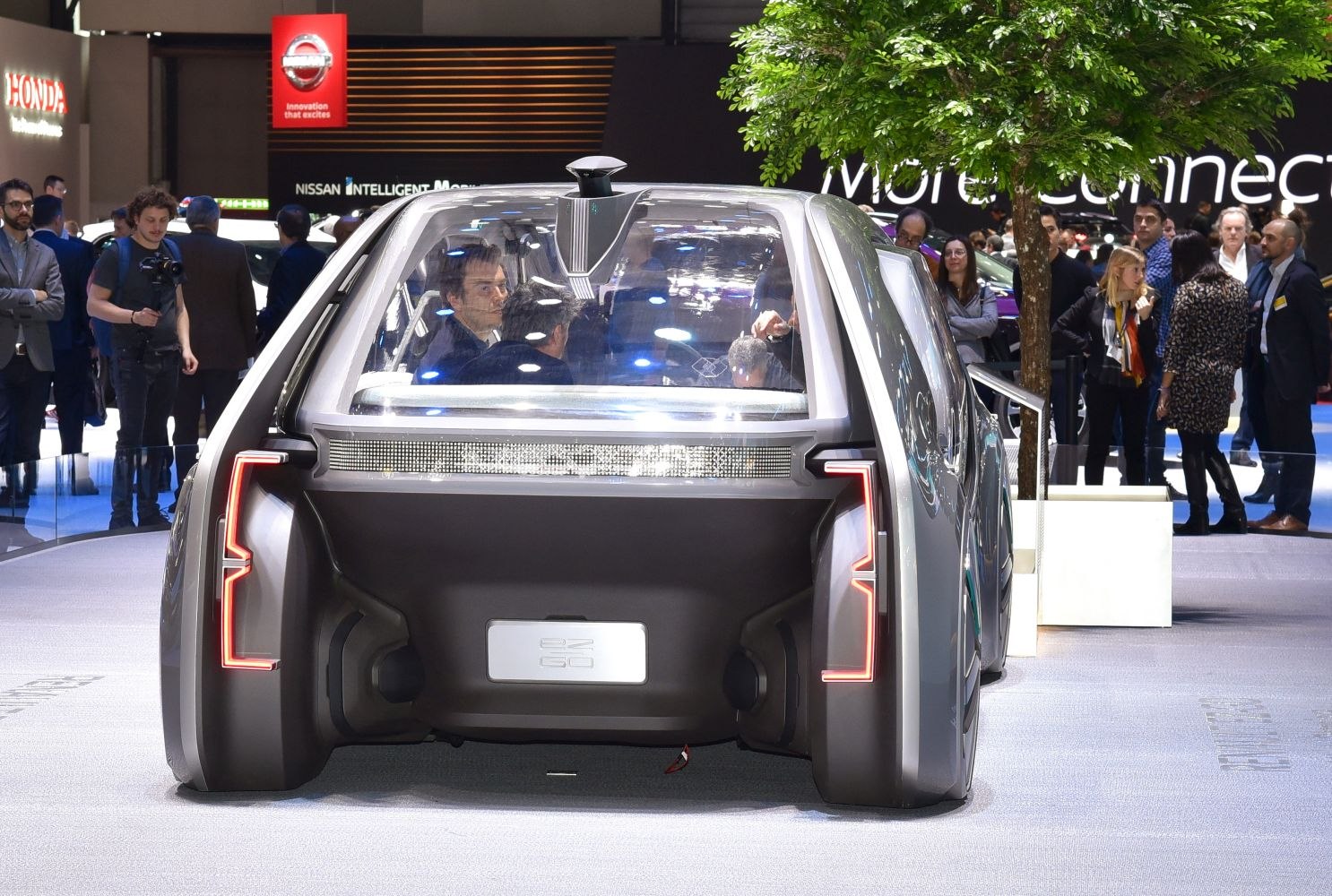 Rear view of futuristic autonomous vehicle with transparent body and LED tailights