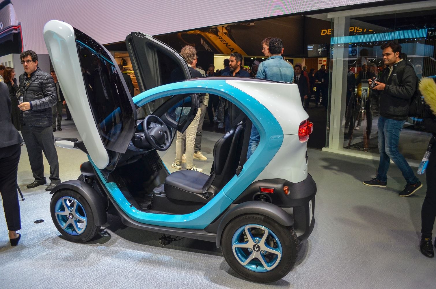 Compact urban two-seater with gullwing doors and blue accent trim