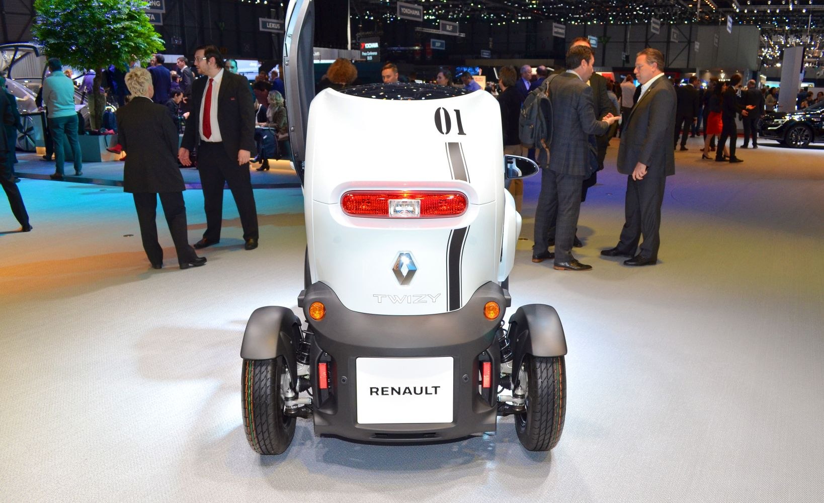 Rear view of compact electric microcar with narrow wheelbase and distinct taillight.