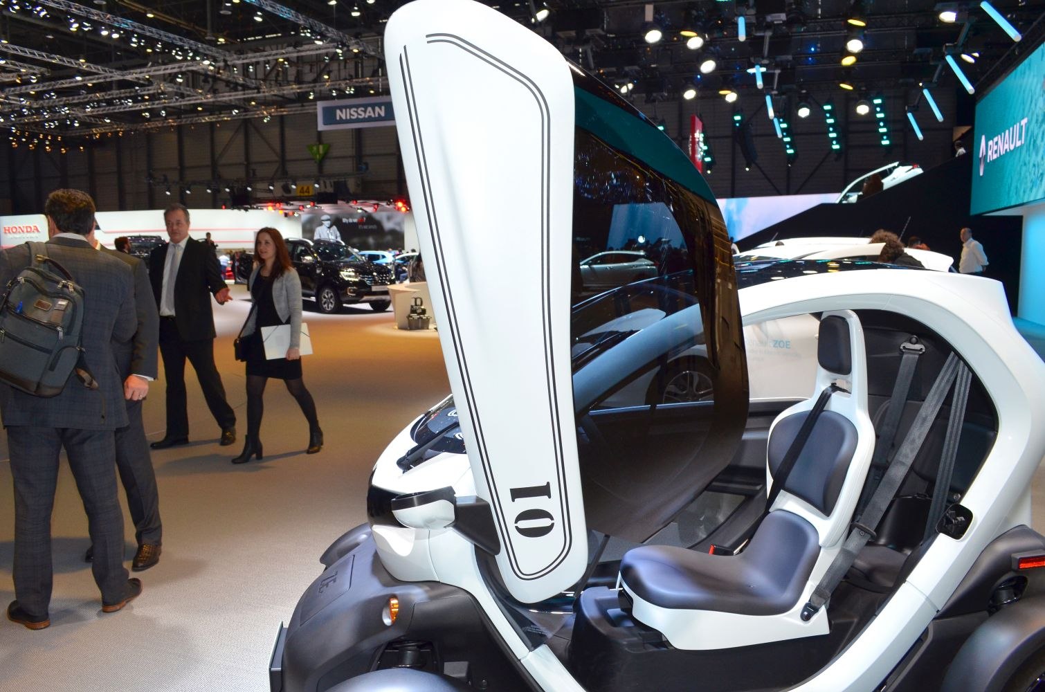Upward-opening canopy door and two-seat compact electric vehicle interior