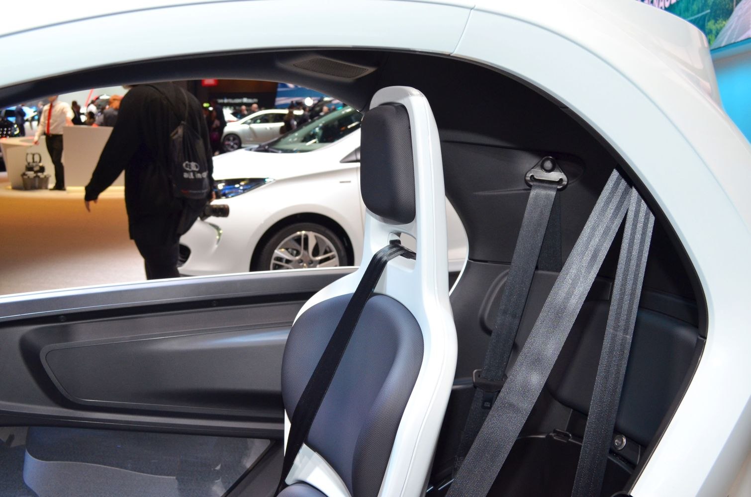 Close-up of modern electric vehicle seat with headrest and seatbelt
