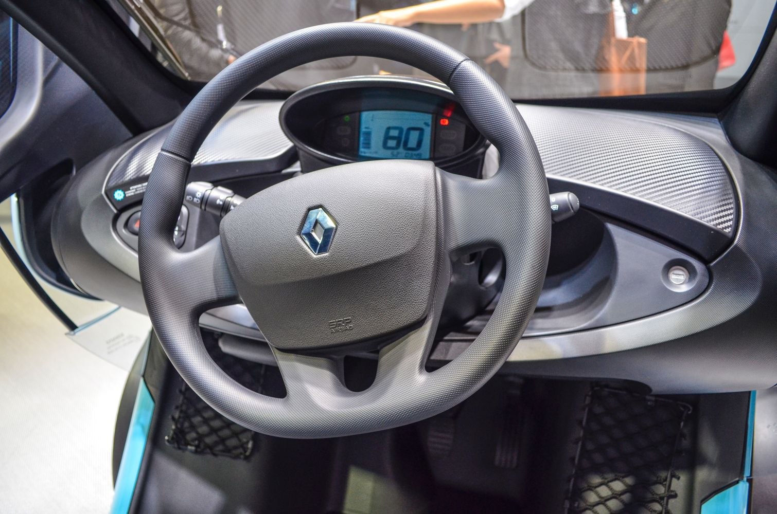 Renault steering wheel and digital speedometer dashboard close-up.