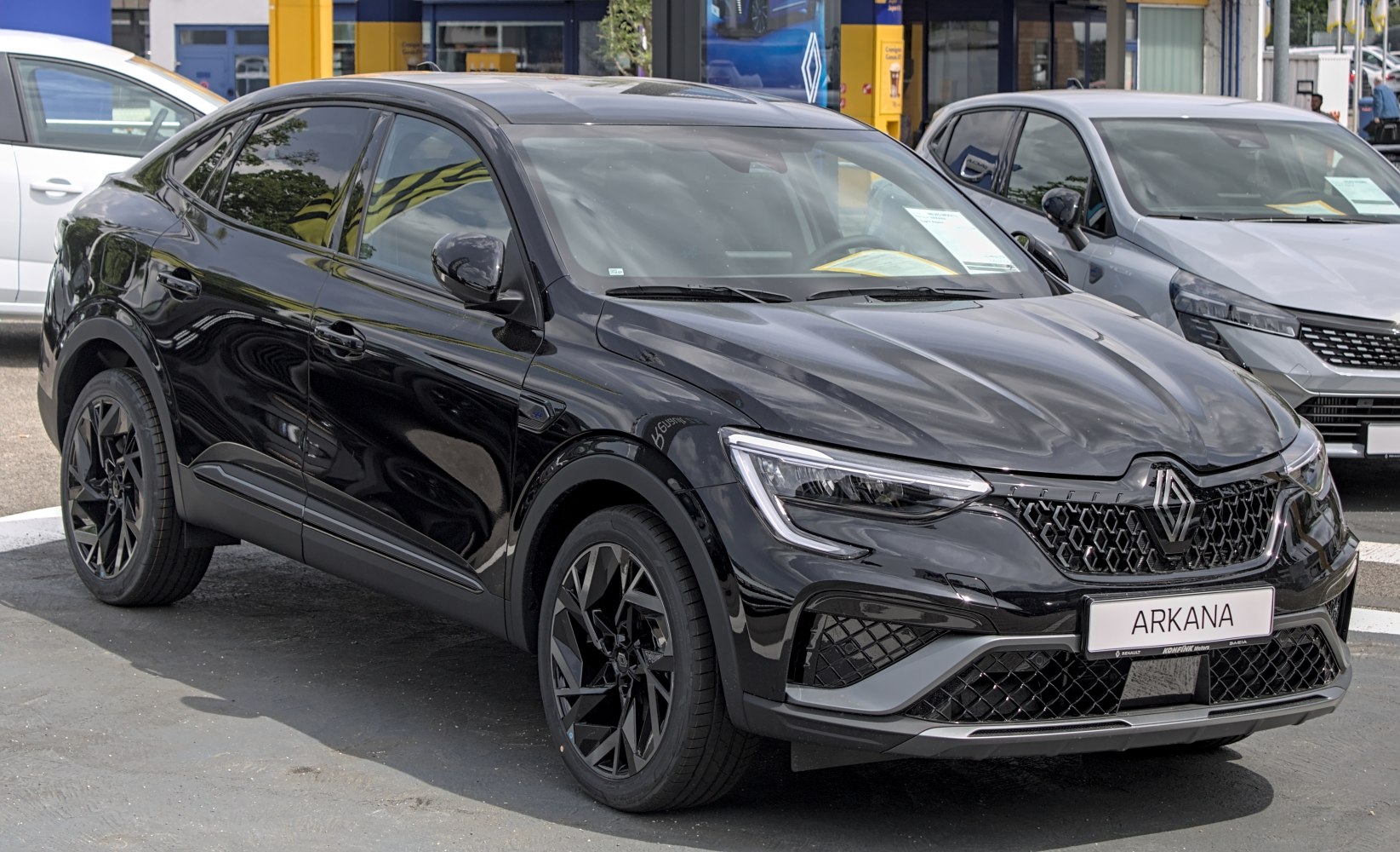 Sleek black coupe SUV with dynamic front grille and black alloy wheels