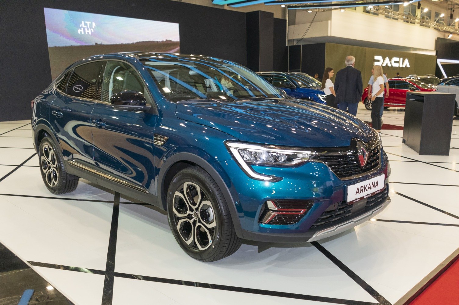 Front side profile with sleek headlights and distinctive alloy wheels