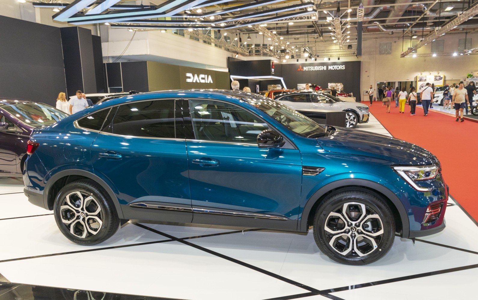 Side profile of sleek SUV with coupe roofline and distinctive alloy wheels