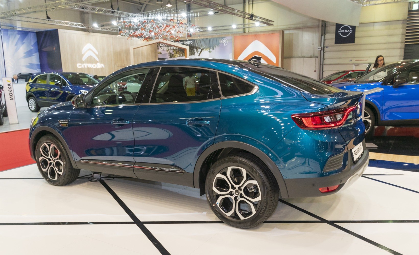 Side profile of a modern coupe-SUV with alloy wheels and rear LED lights