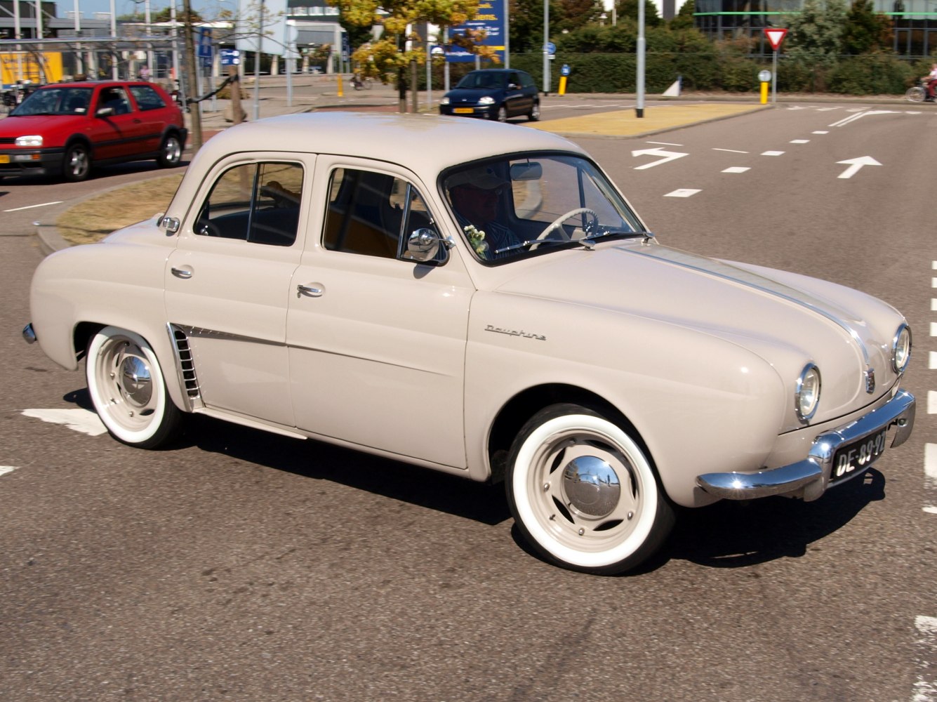 Vintage sedan with round headlights, whitewall tires, and chrome details