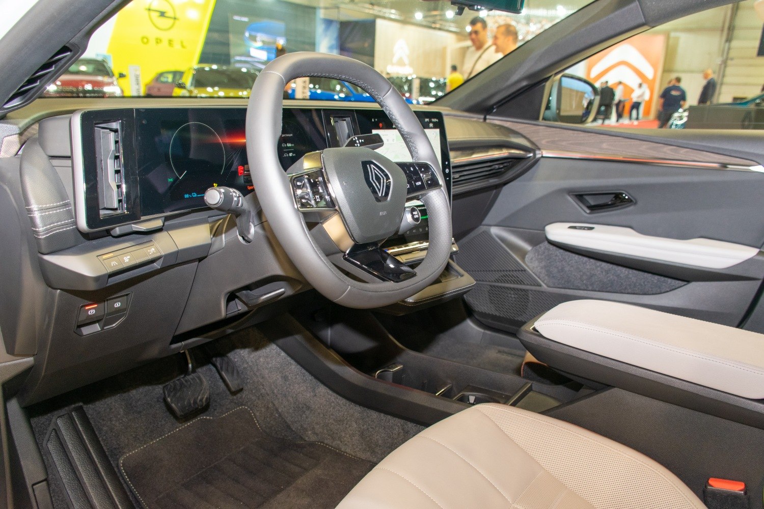 Digital dashboard and steering wheel with controls inside modern vehicle cabin