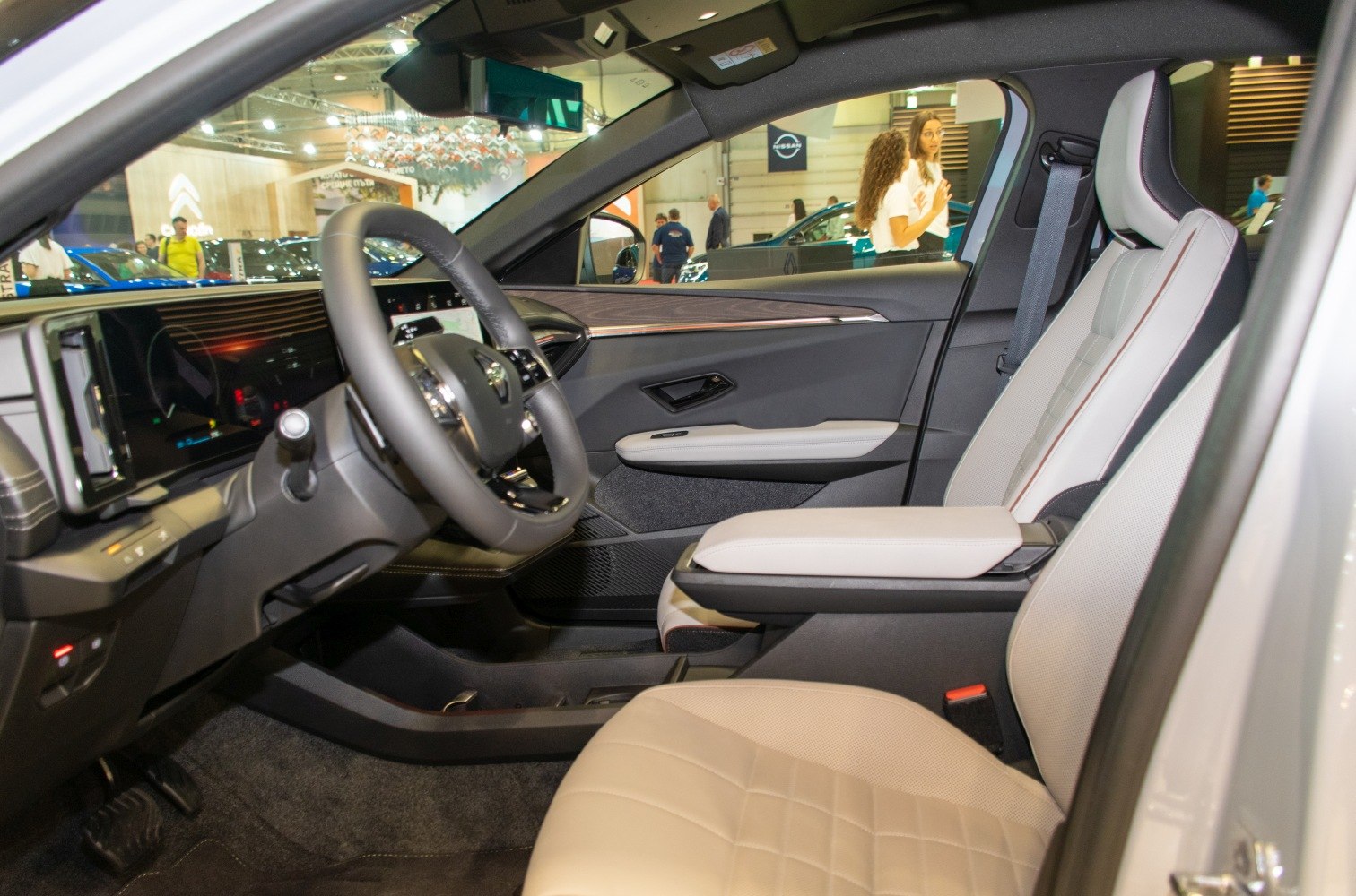 Modern digital dashboard and beige leather seating with armrest