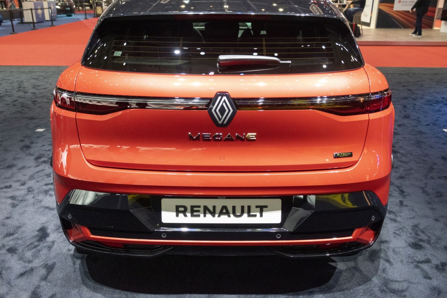 Rear view of a sleek electric hatchback with taillights and rear wiper