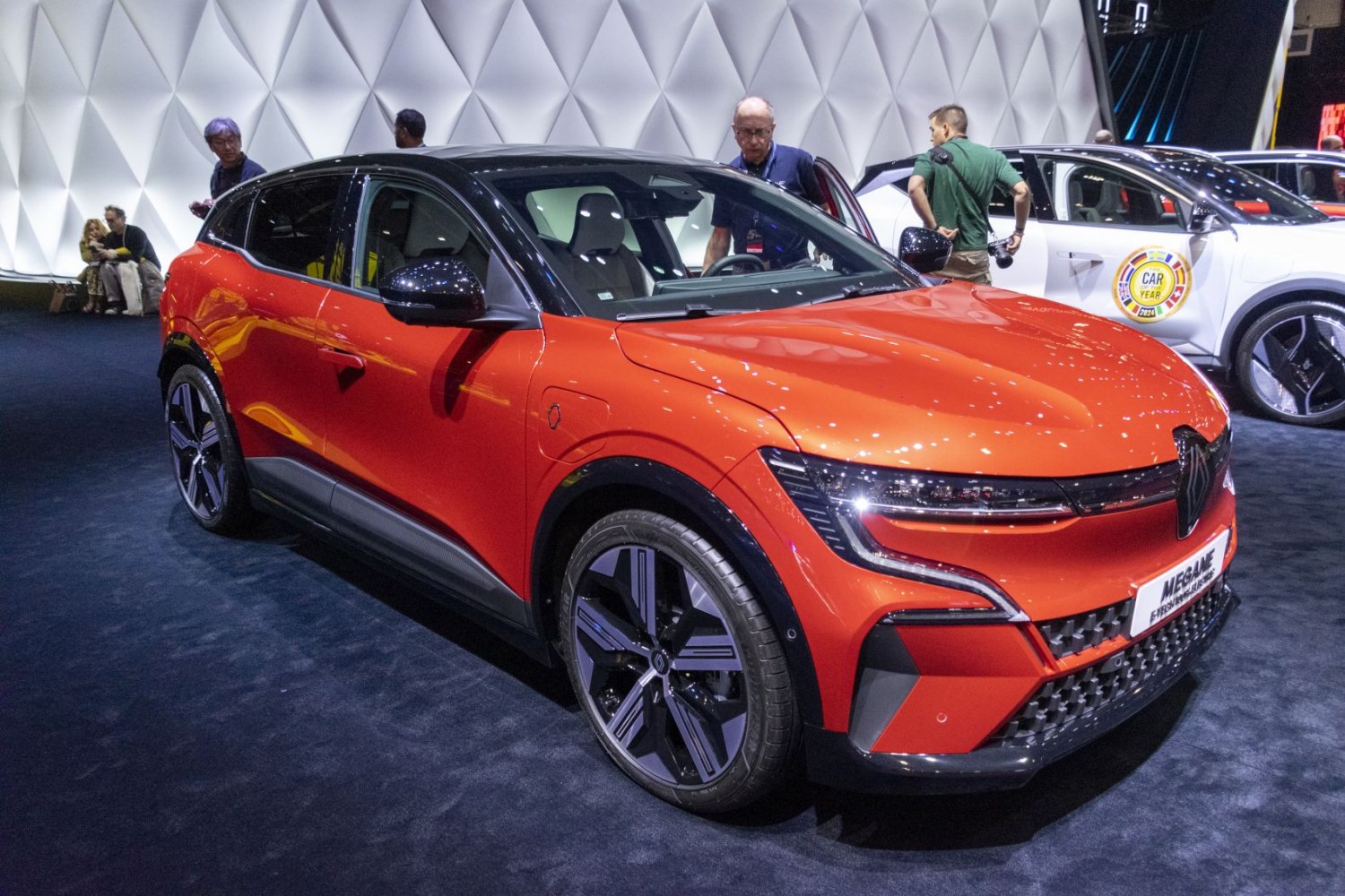 Orange electric SUV front and side profile with modern lighting and alloy wheels
