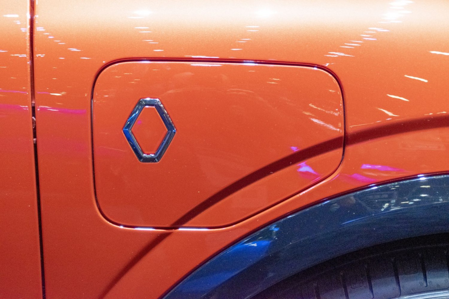 Orange side charging port with stylized emblem