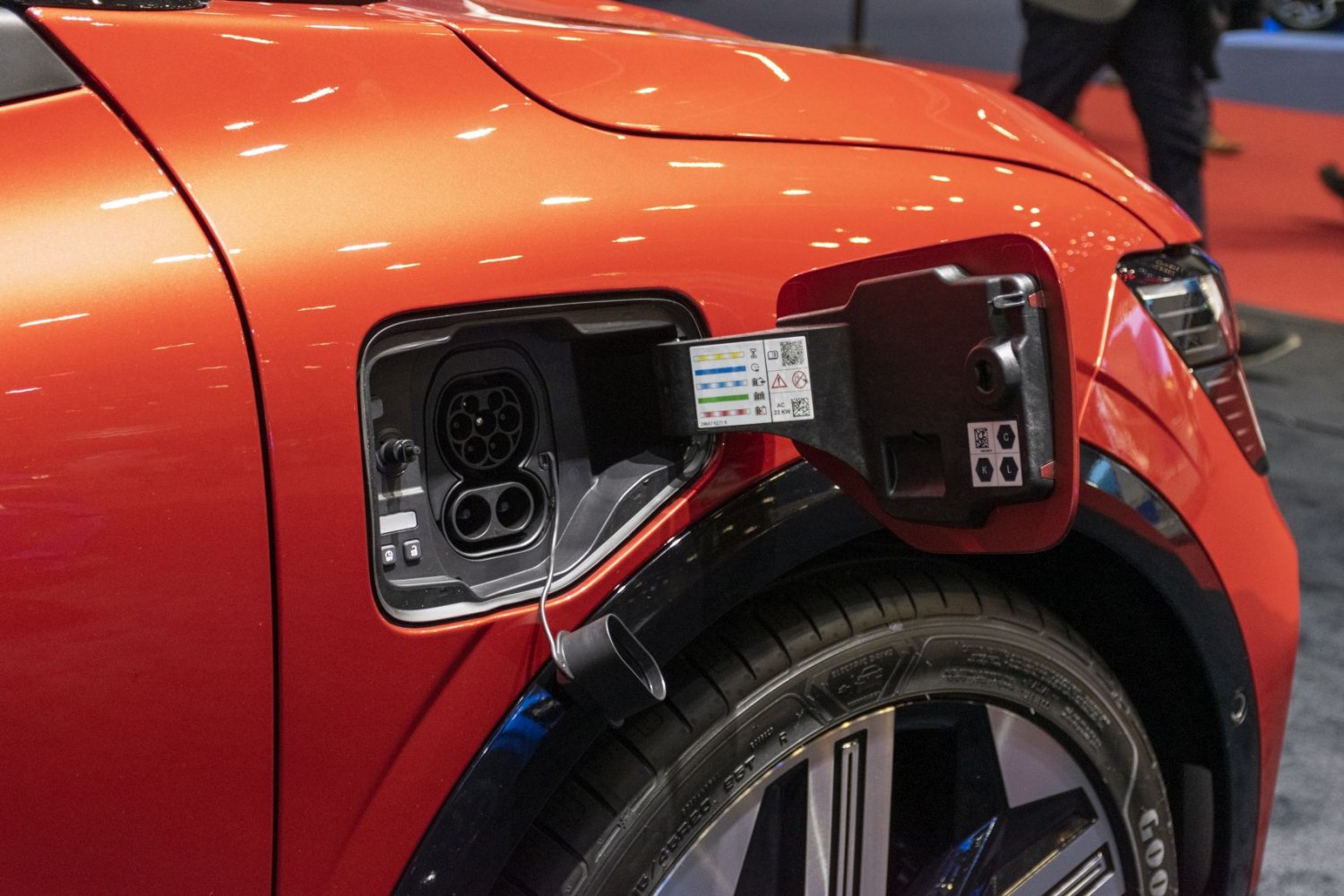 Close-up of electric vehicle charging port and wheel
