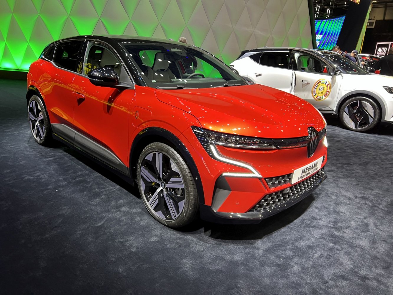 Red electric hatchback with modern LED headlights and sporty alloy wheels