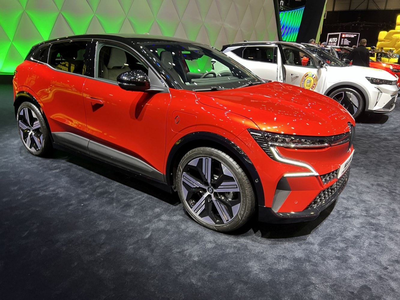 Modern electric crossover with sharp LED lights and black roof contrast.