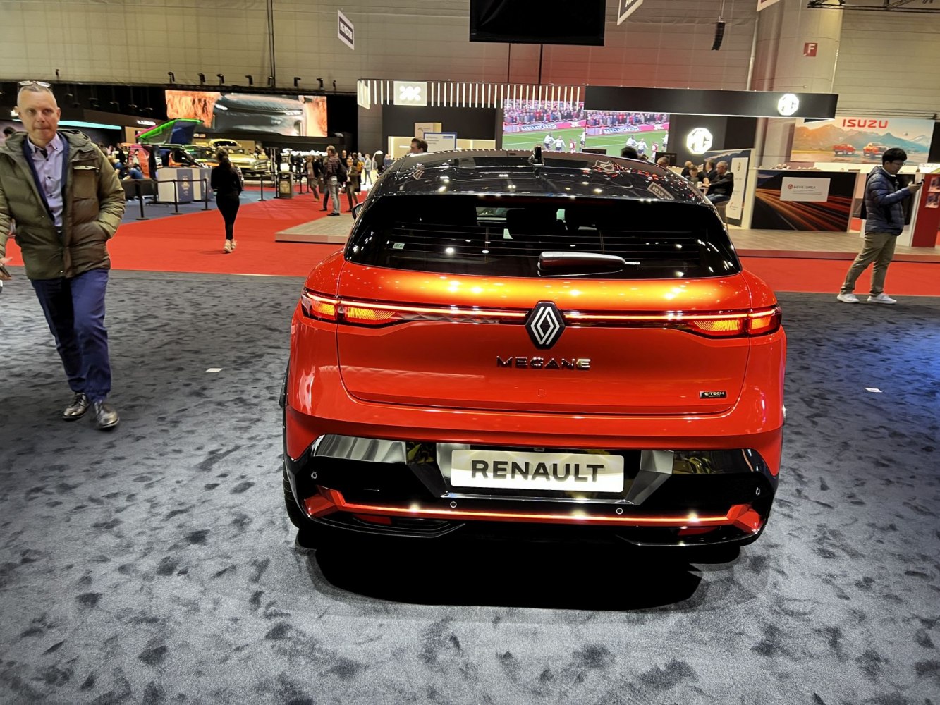 Rear view of modern electric hatchback with sleek taillights and black roof.