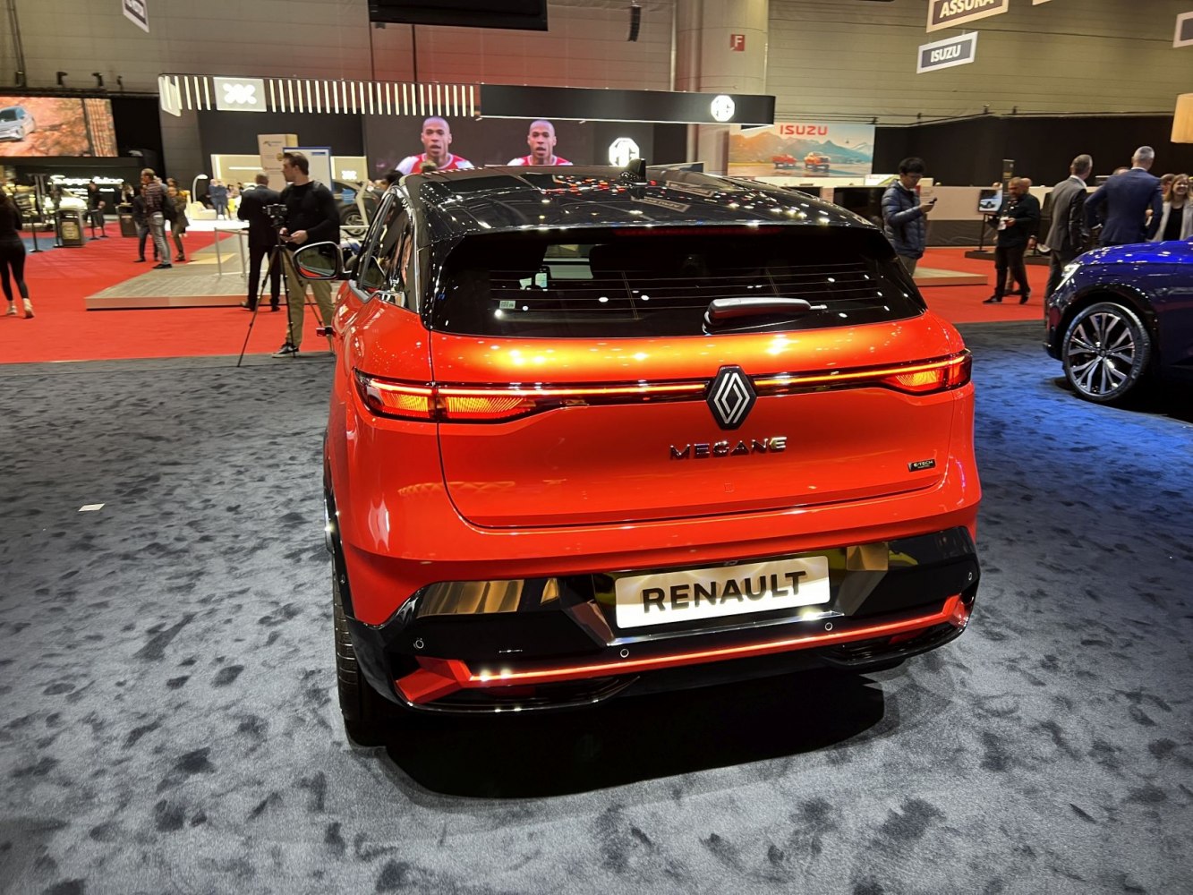 Rear of a modern electric hatchback with sleek taillights and distinctive badge.