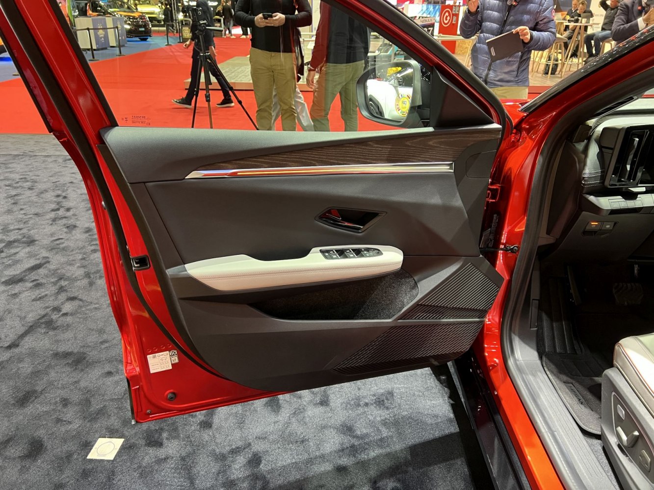 Close-up of modern car interior door panel with controls and trim