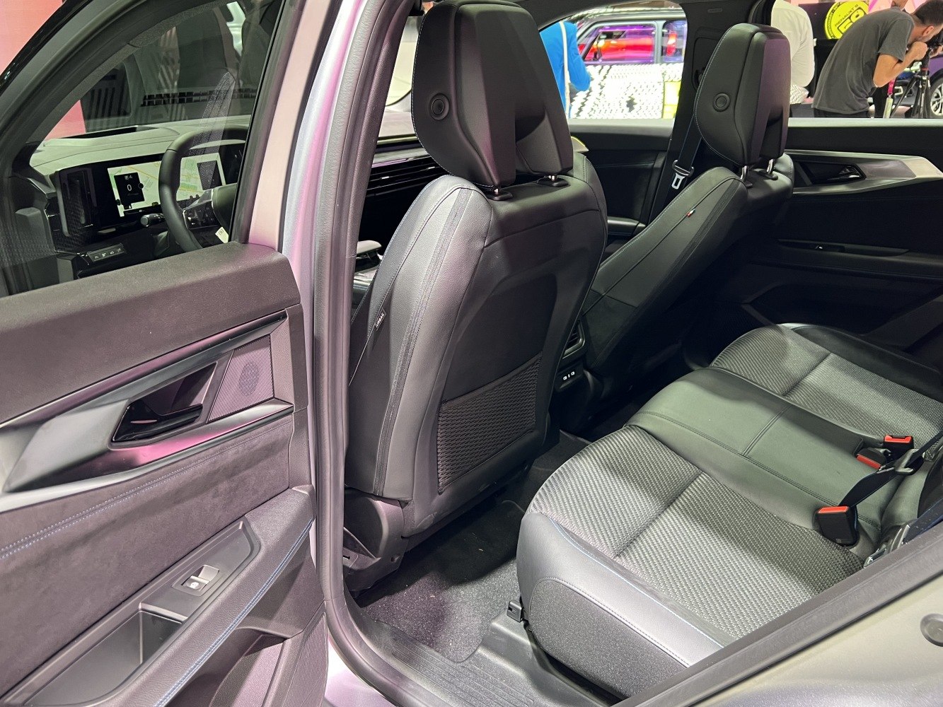 Rear passenger seats and door panel with window control and storage compartment