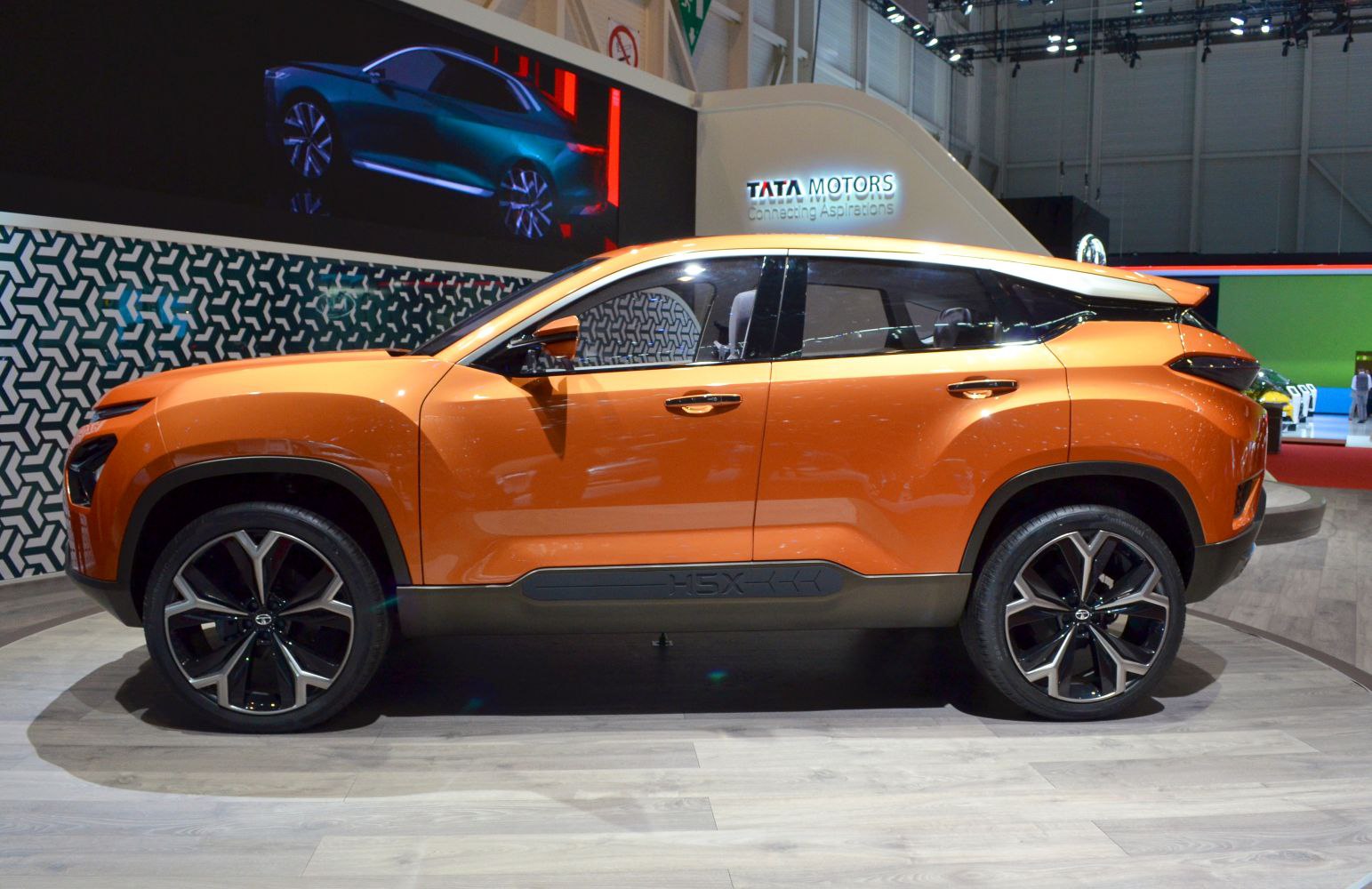 Side profile of orange SUV with large modern wheels and dynamic design