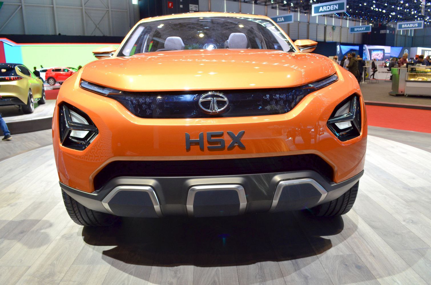 Bold front grille and futuristic LED headlights in orange concept SUV