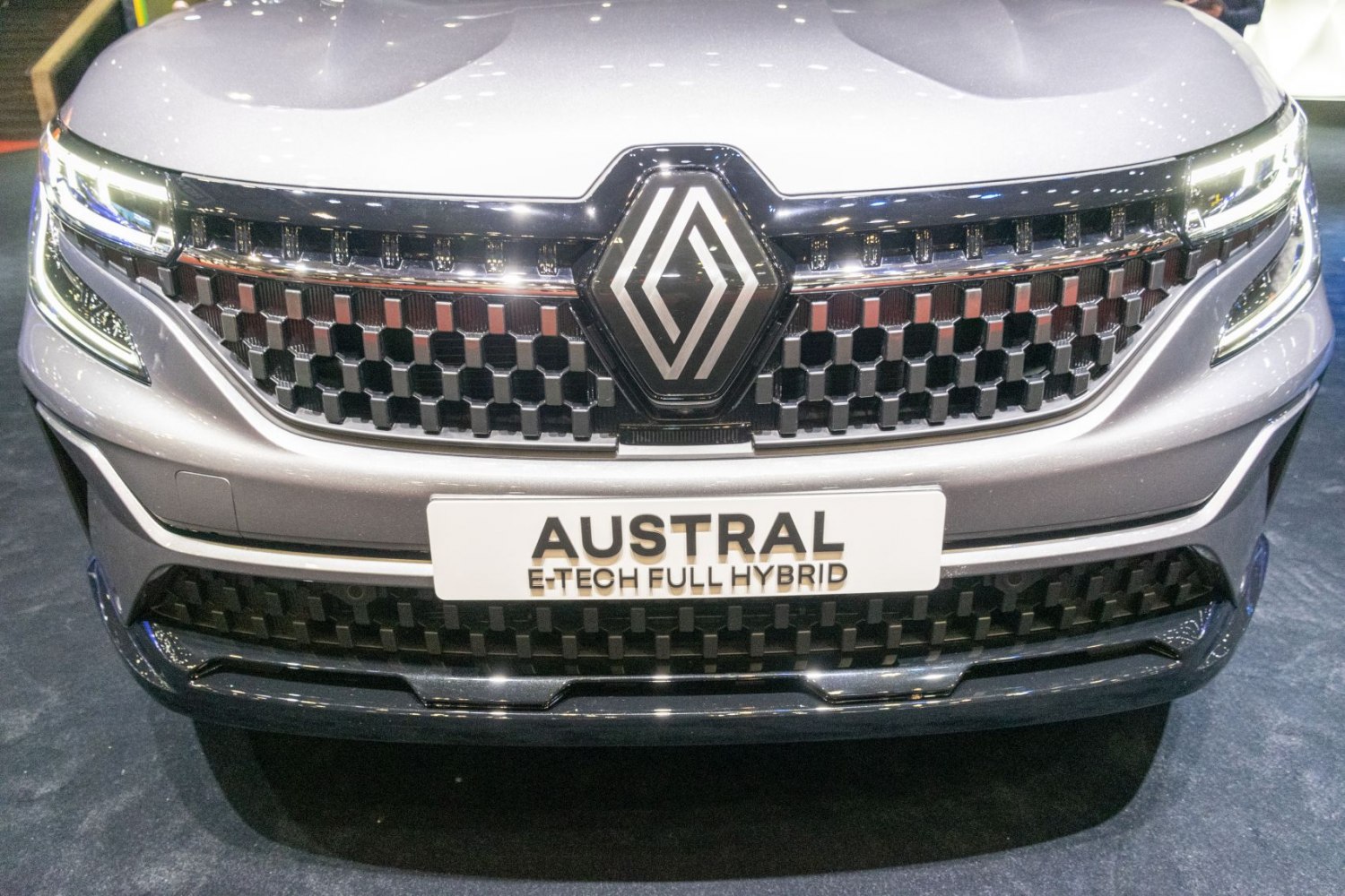 Close-up of front grille and hybrid badge of a modern hybrid SUV