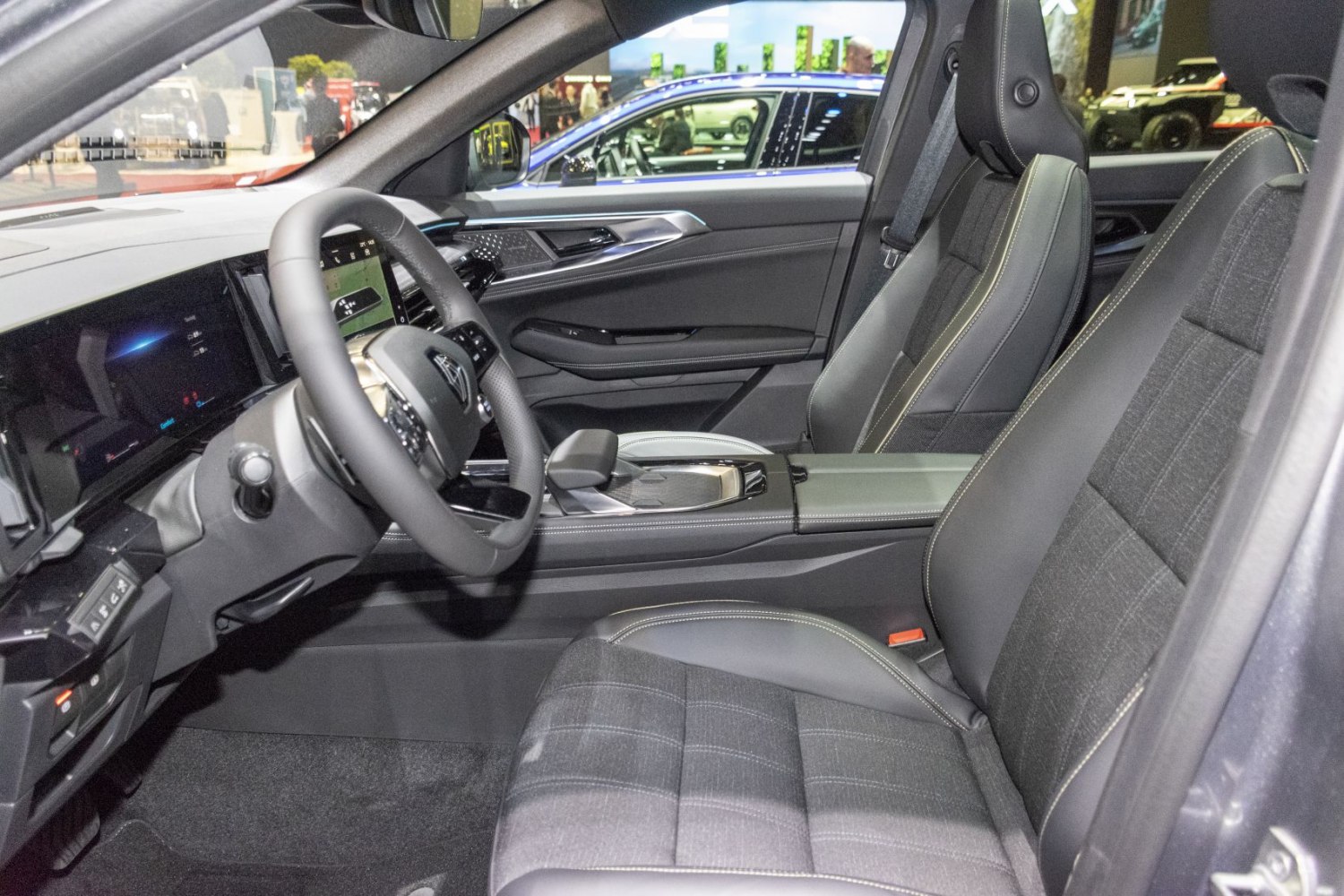 Modern driver and front passenger seats with digital dashboard and sleek center console