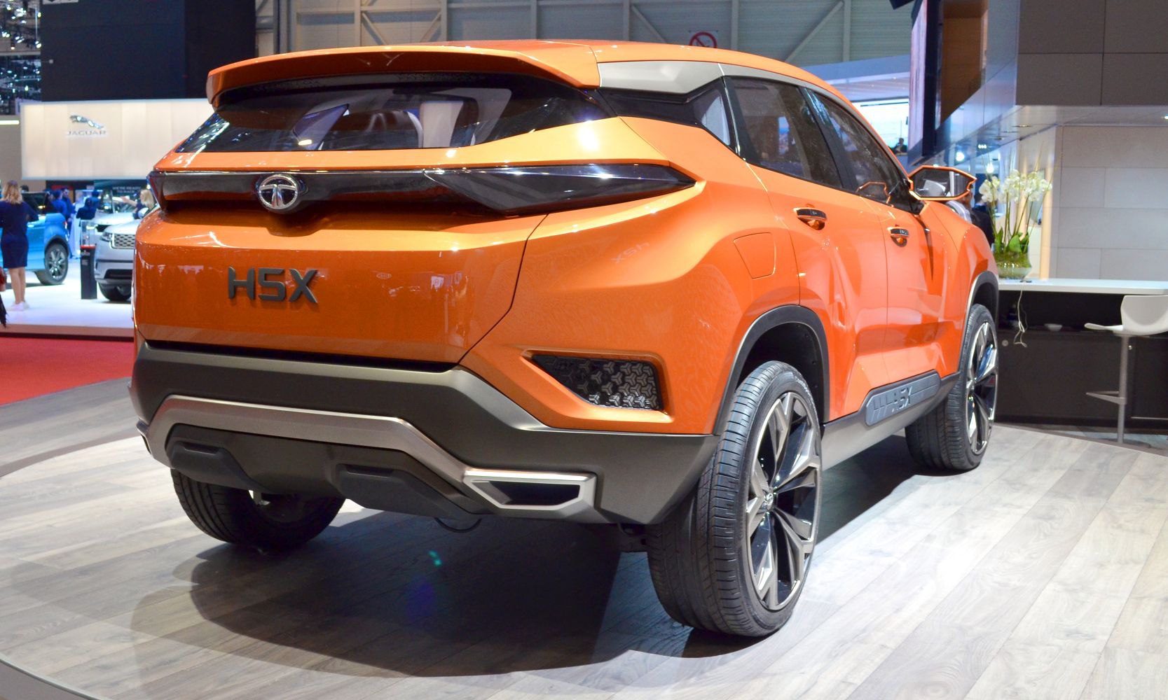 Bold orange SUV rear with sleek tail light bar and large alloy wheels