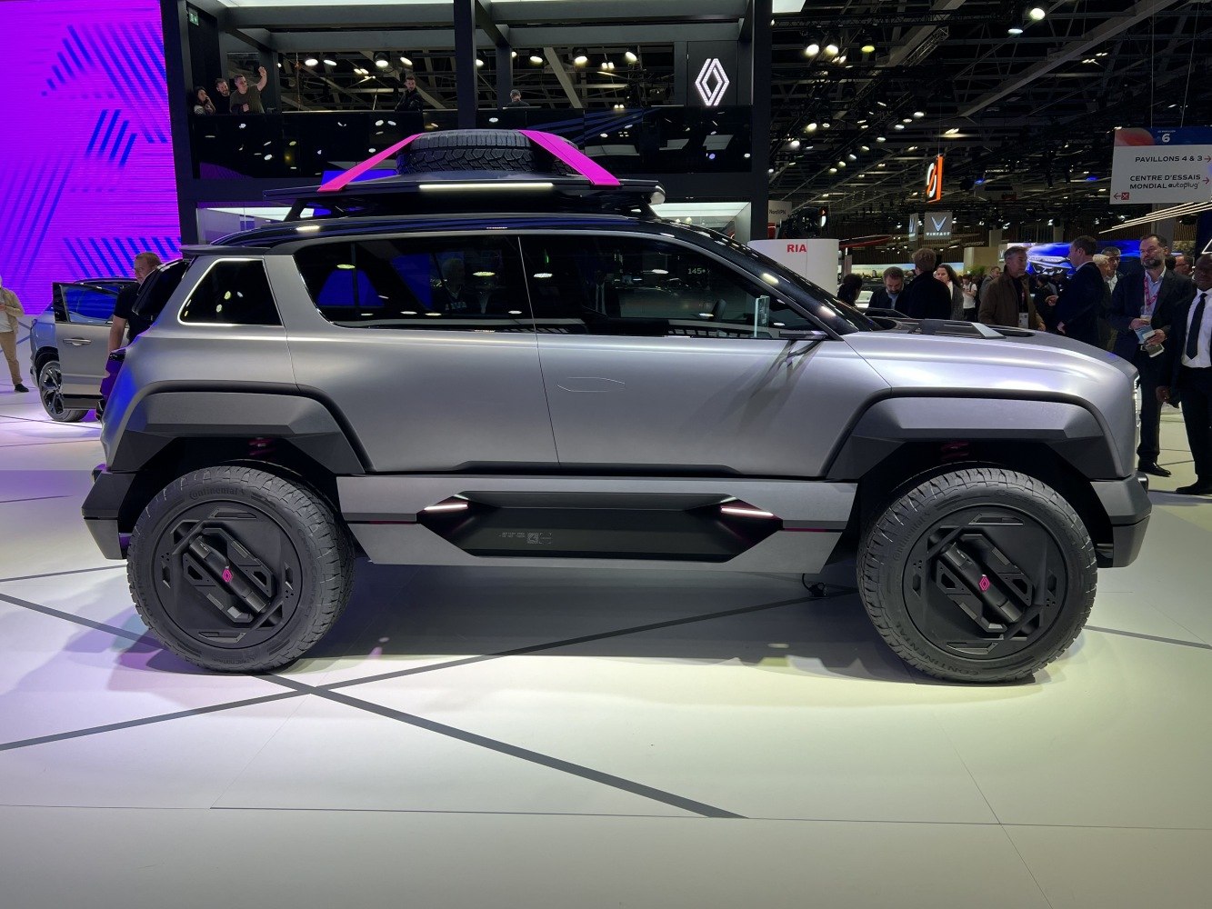 Futuristic SUV with roof spare tire and geometric wheel covers