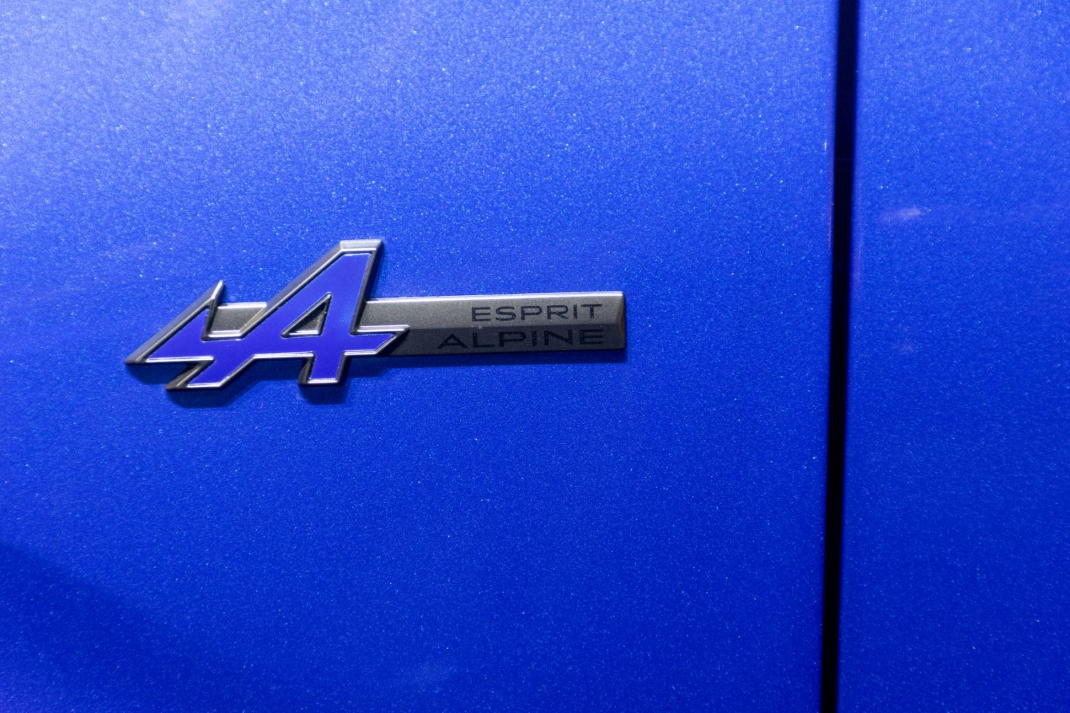Close-up of Esprit Alpine badge on blue metallic surface