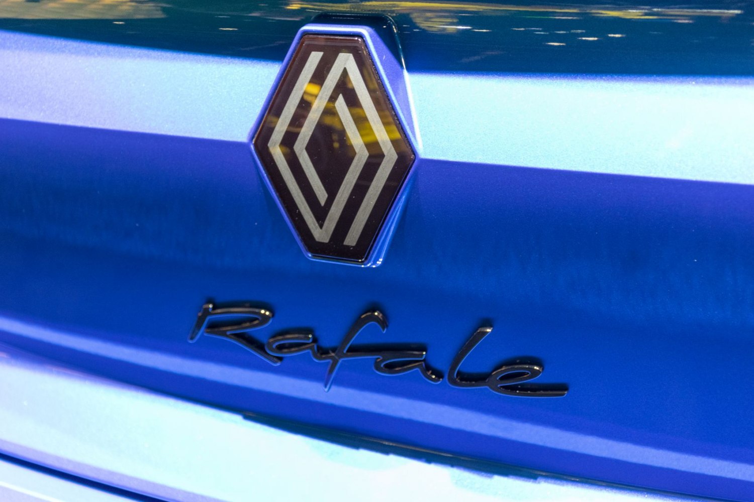 Close-up of Renault Rafale badge and logo on blue paint