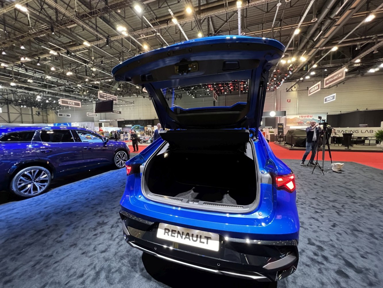 Rear view of SUV with open spacious trunk at auto show