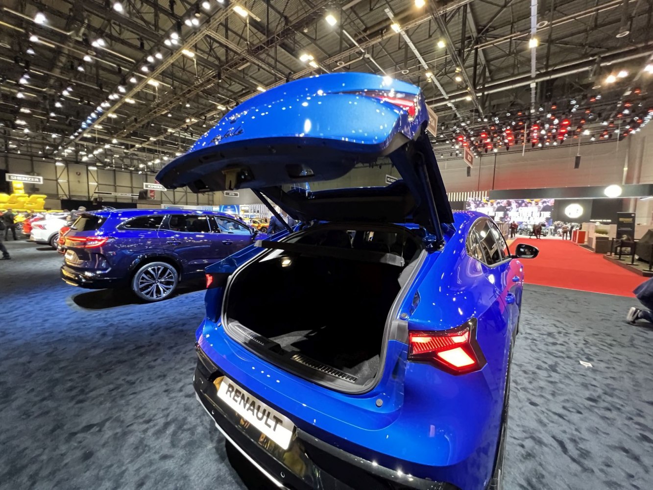 Blue hatchback with open rear trunk and distinct rear lights