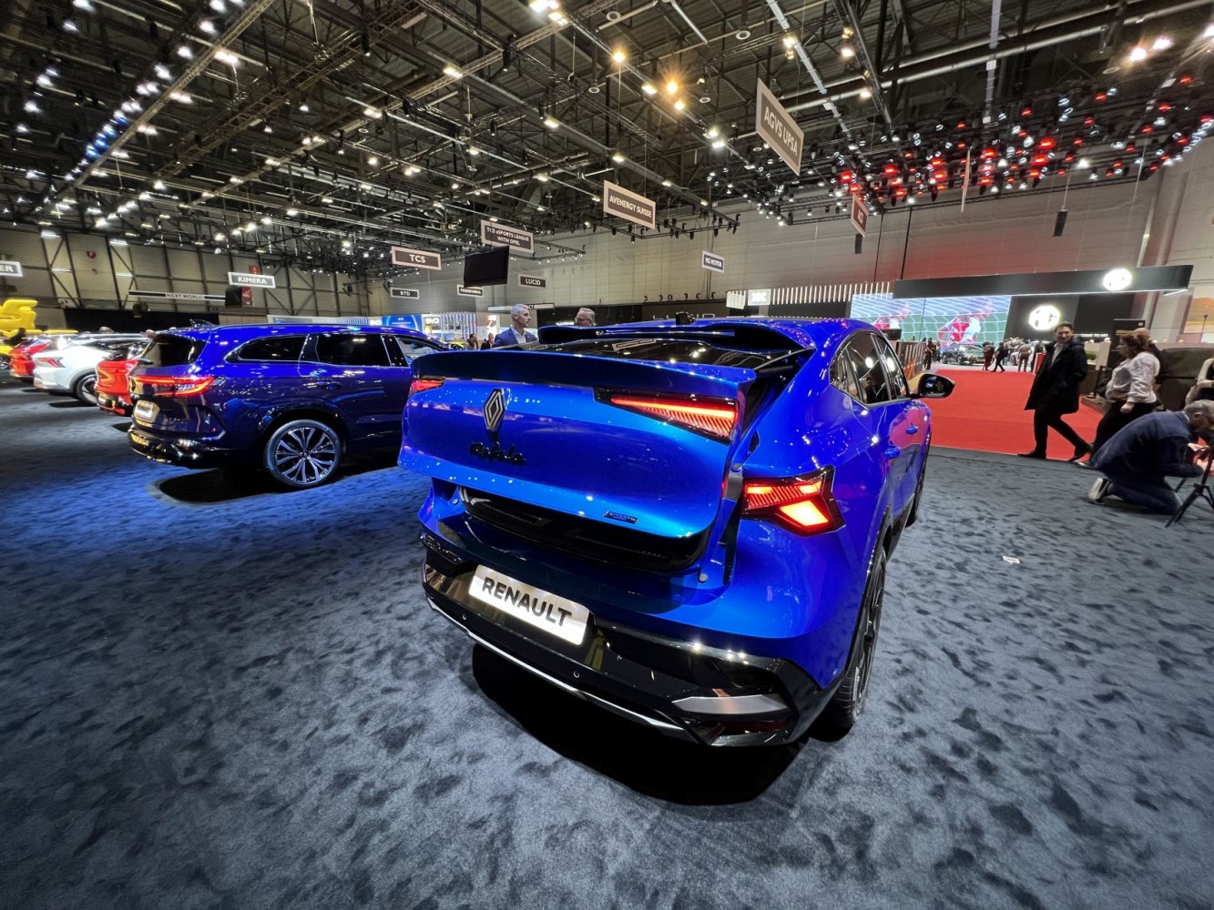 Rear view of blue vehicle with open tailgate and distinctive LED taillights