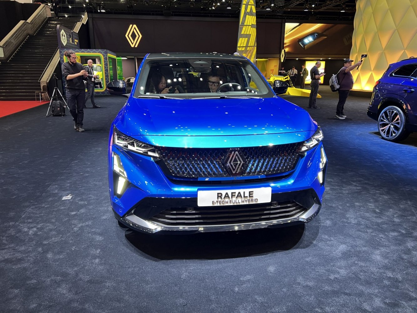Bold front design with LED headlights and black patterned grille in blue.