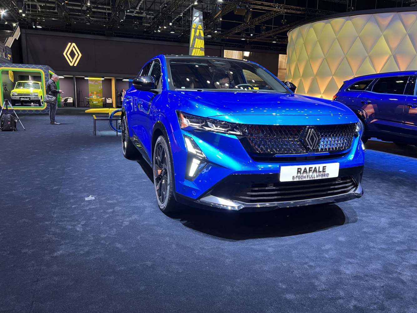 Blue SUV front with distinctive grille and LED headlights.