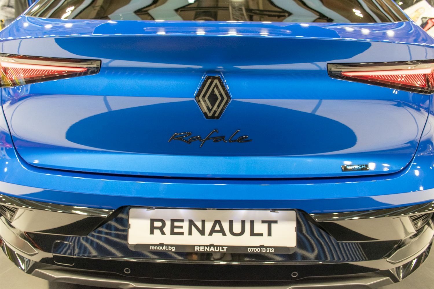 Rear view with sleek taillights and central emblem.