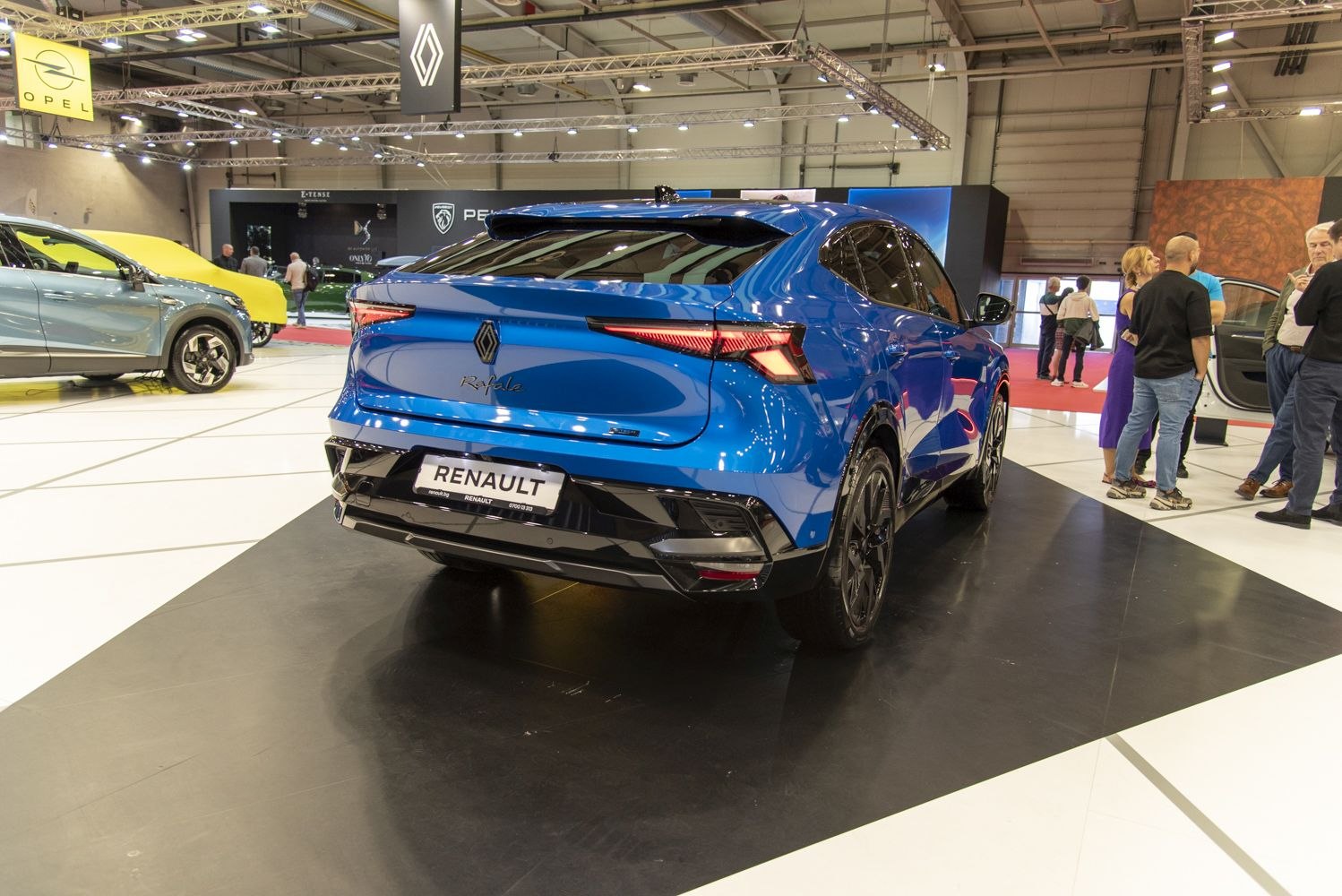 Rear view of a sleek blue vehicle with LED tail lights and sporty spoiler