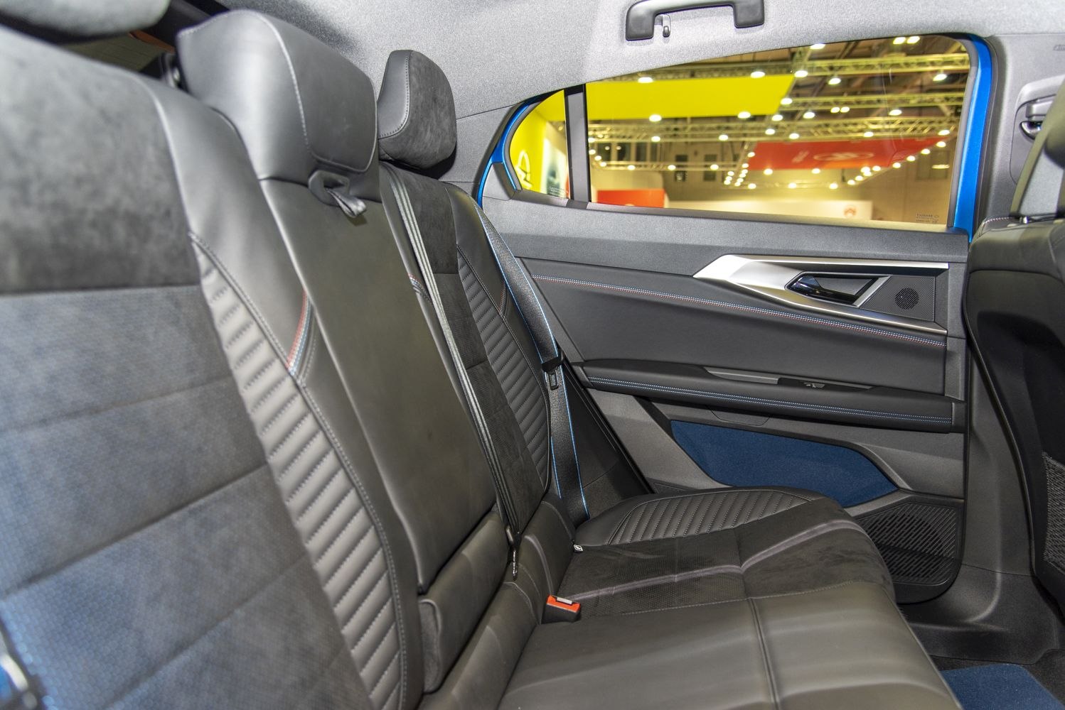 Premium leather rear seats with modern door panel and headrests