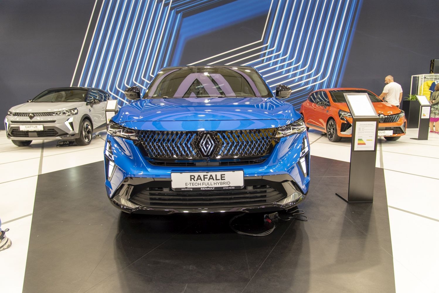 Front view of a blue SUV with distinctive grille and headlights