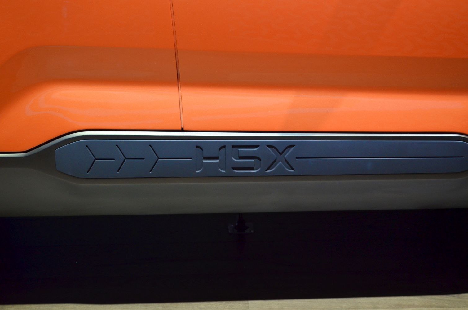 Close-up of embossed H5X lettering on side panel with design accents
