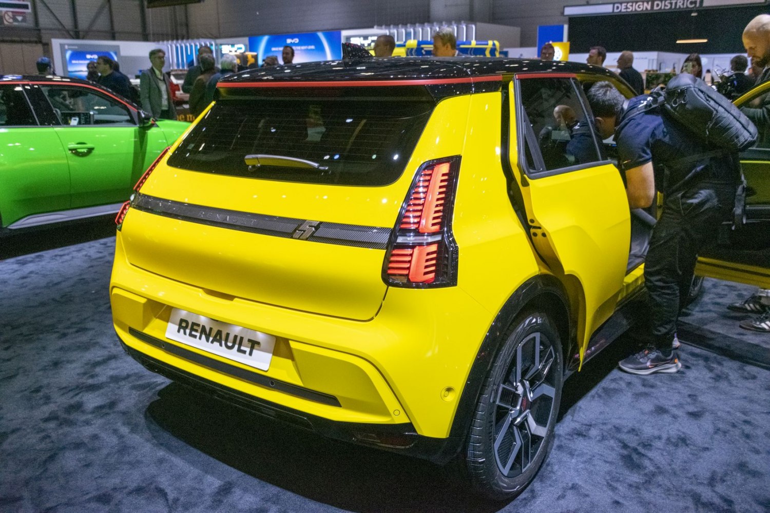 Rear view of a yellow hatchback with signature vertical LED tail lights and black roof