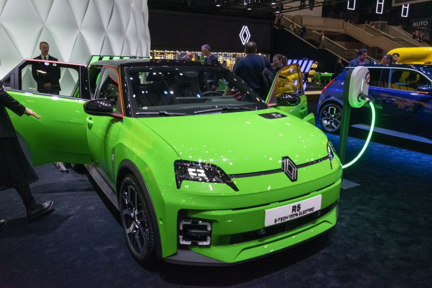 Bright green compact electric car with open doors and modern headlights