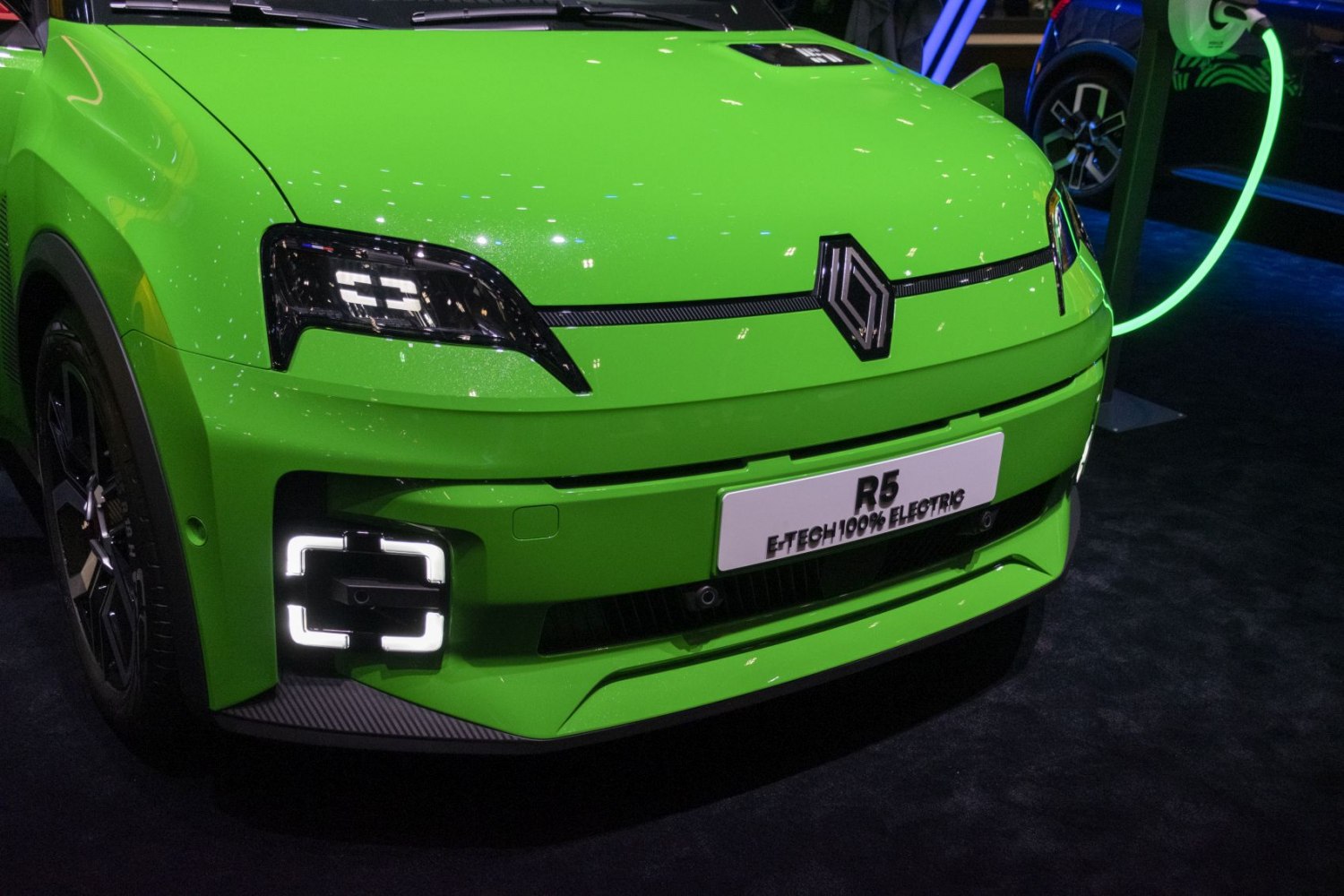Front grille with Renault logo and unique LED headlights on bright green EV