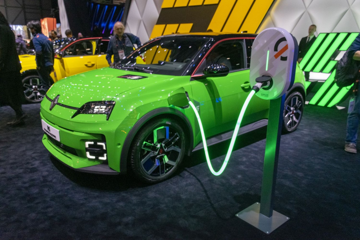 Compact electric hatchback charging at station, LED headlights