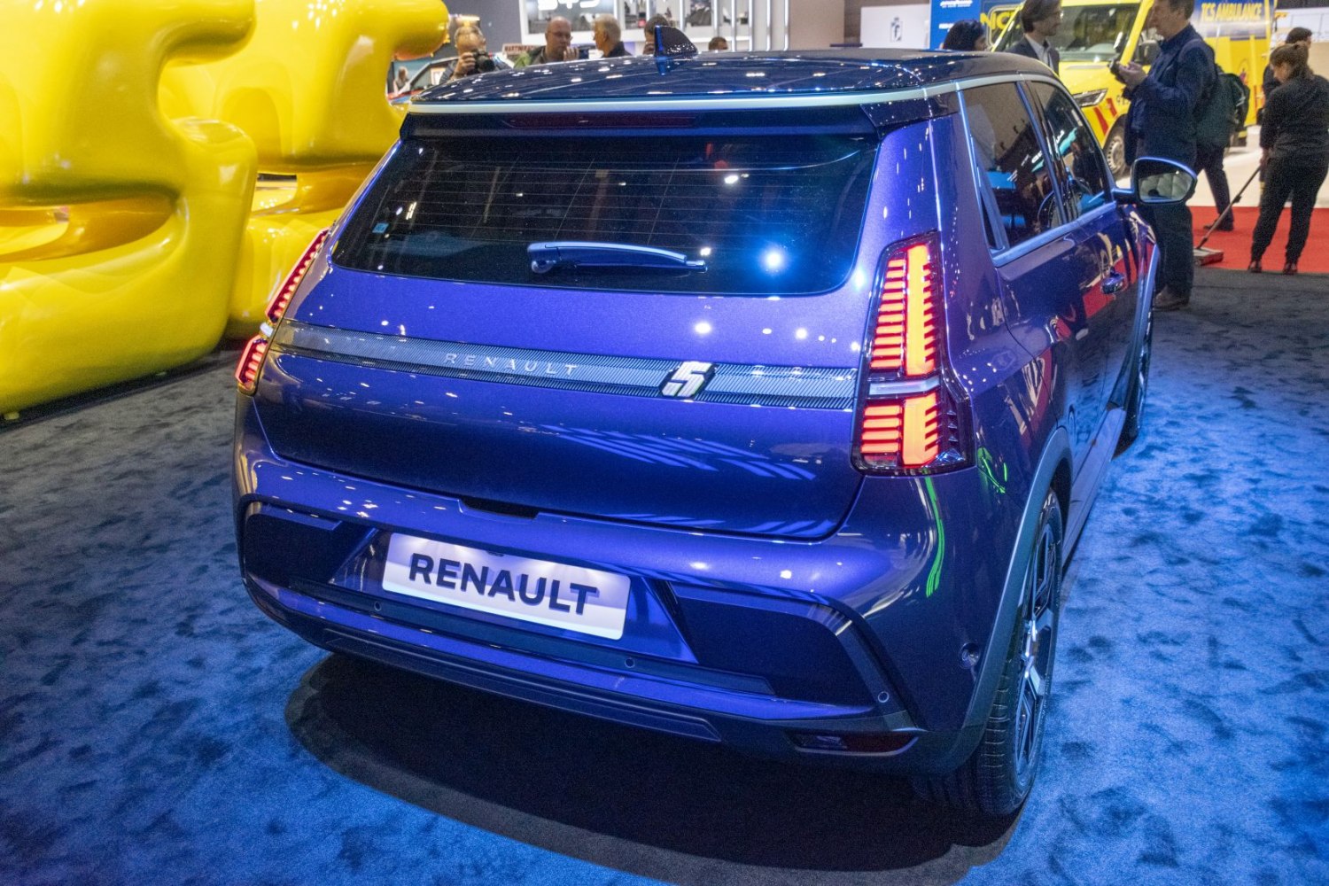 Rear view of a compact hatchback with vertical LED taillights and roof spoiler.