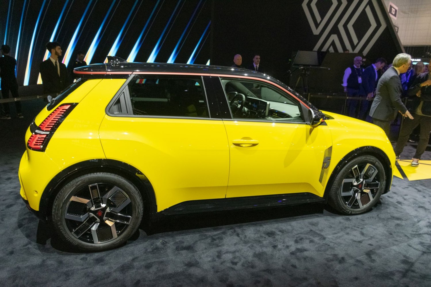 Side profile of a compact electric hatchback with two-tone roof and modern alloy wheels