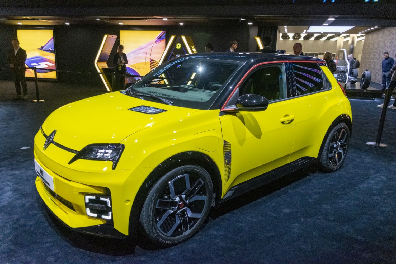 Electric compact hatchback with yellow body, black roof, and distinctive LED lights