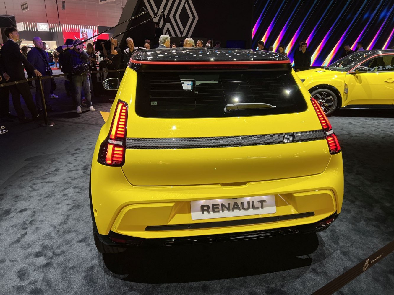 Yellow hatchback rear view with vertical LED taillights and black roof